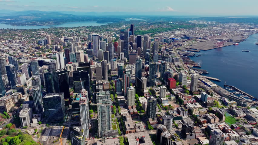 Aerial view over Seattle, Washington, USA, capturing the downtown skyline, urban landscape, and surrounding city environment from above. Ideal for travel and cityscape footage