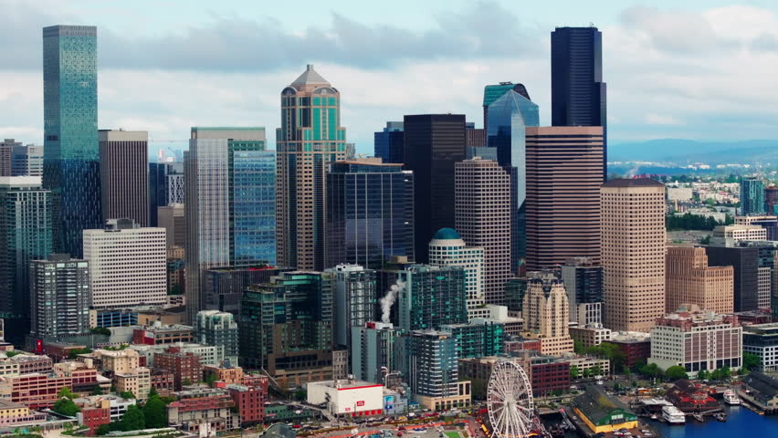 Aerial drone view of downtown Seattle, showcasing skyscrapers, urban streets, and the city skyline from above. Ideal for travel and urban cityscape footage