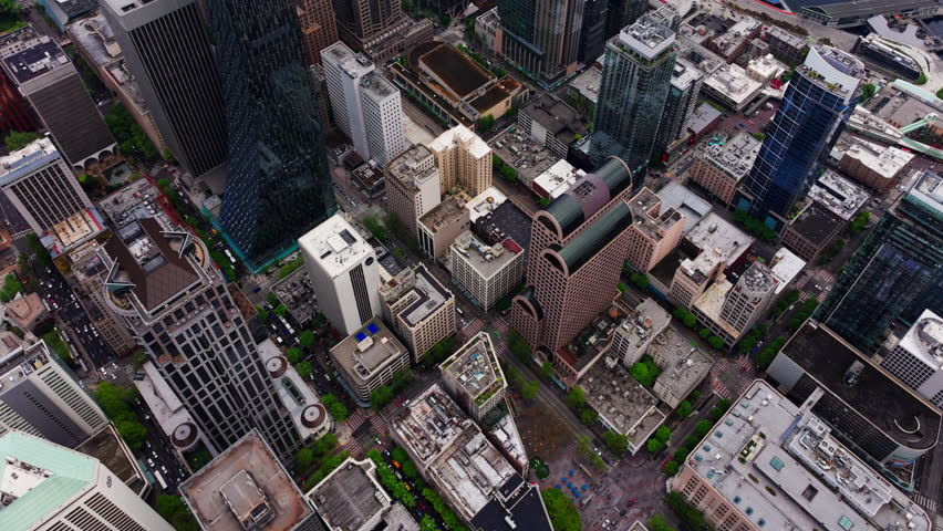 Aerial drone view of downtown Seattle, Washington, showcasing skyscrapers, urban streets, and the city’s modern skyline from above. Ideal for travel, cityscape, and urban environment footage
