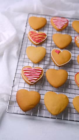 Delicious heart shaped cookies with decorative pink and white icing for Valentine