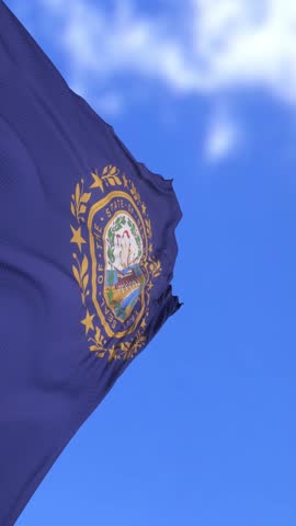 New Hampshire State Flag Waving Against Clear Blue Sky on a Sunny Day