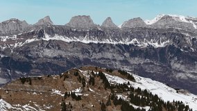 Aerial view of the Churfirsten mountain range above Walensee and Flumserberg in Switzerland, featuring dramatic alpine peaks such as Selun, Brisi, and Hinterrugg in winter scenery. - Powered by Shutterstock - Get 15% off with code: PIKWIZARD15