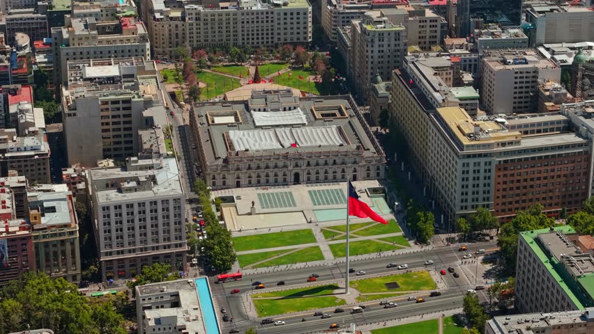 Aerial Establishing fly Moneda Palace and Chilean Flag at Santiago de Chile downtown Square, city center