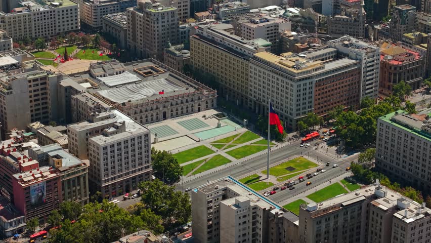 Aerial Establishing fly Santiago de Chile Downtown with National Flag, La Moneda Palace and City Traffic