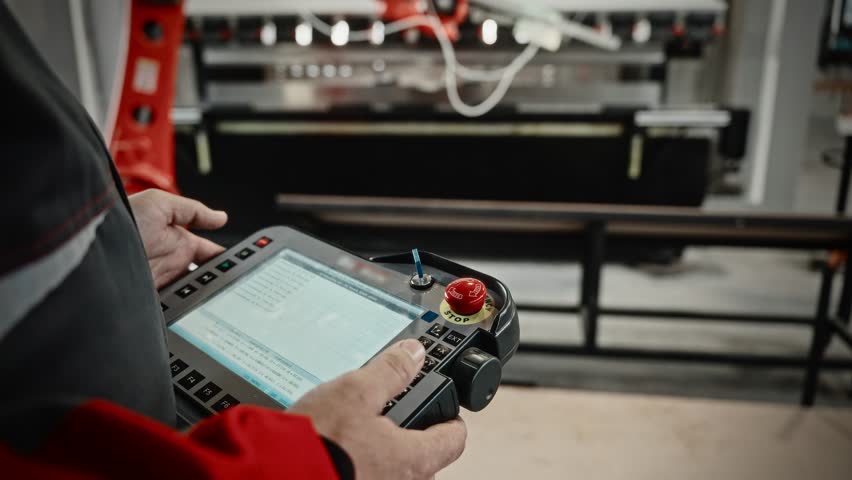 Engineering Specialist Configures Robotic Equipment With Sensors And Safety Features In Factory Setting