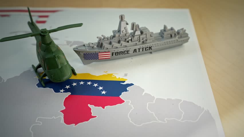 Plastic toys representing a US warship and a helicopter moving over a map of Venezuela, symbolizing the political crisis, sanctions, and military intervention between the two countries