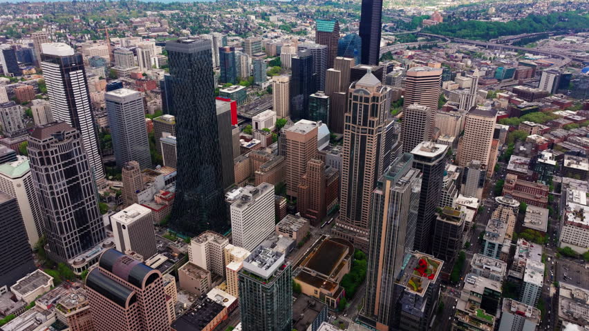 Aerial drone view of downtown Seattle, Washington, showcasing skyscrapers, urban streets, and the city’s modern skyline from above. Ideal for travel, cityscape, and urban environment footage