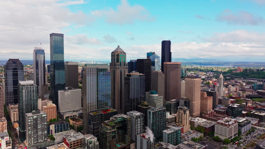 Aerial view over Seattle, Washington, USA, capturing the downtown skyline, urban landscape, and surrounding city environment from above. Ideal for travel and cityscape footage