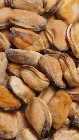 Cooking tempura chicken nuggets in deep fryer. Closeup. Vertical footage