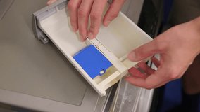 Technician carefully assembling washing machine drawer components on bench, Detailed scene of technician reassembling washing machine parts with precise finger placement and clips - Powered by Shutterstock - Get 15% off with code: PIKWIZARD15