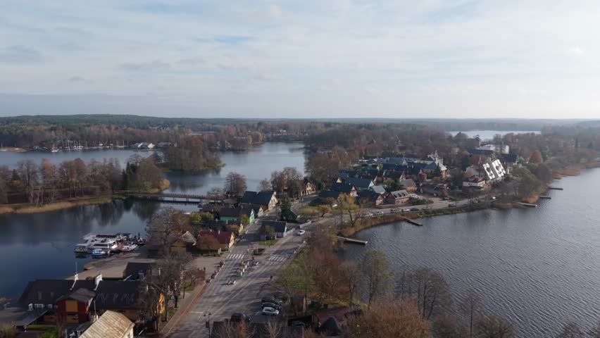 Trakai, Lithuaniai Aerial View Harborside Town Center Market, Busy Quay With Parked Cars, Cafes And Shops Lining Waterfront, Small Boats Moored Along Promenade, Autumn Trees And Historic
