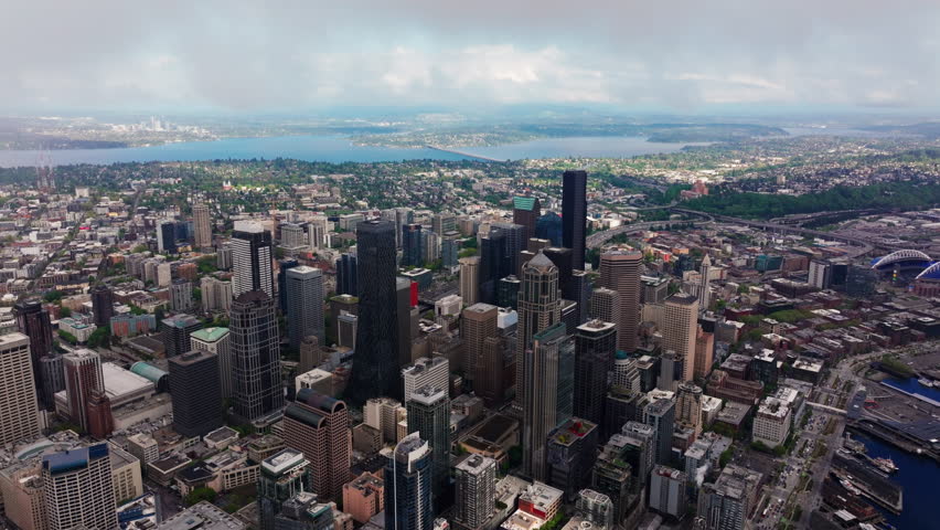 Aerial view over Seattle, Washington, USA, capturing the downtown skyline, urban landscape, and surrounding city environment from above. Ideal for travel and cityscape footage