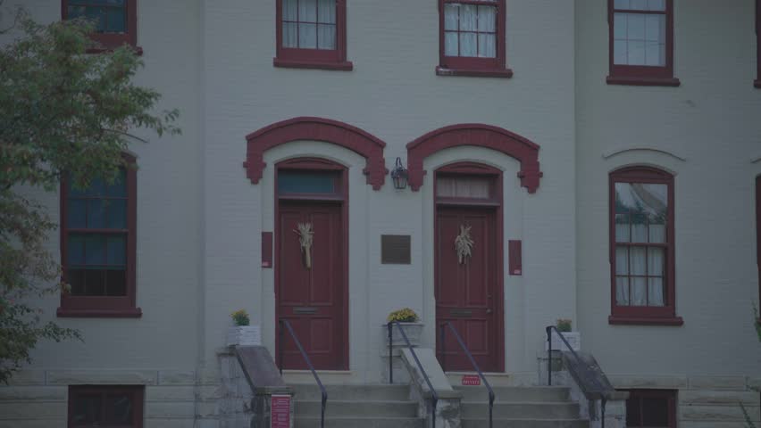 Twin red doors and historic facade of the keeper’s house at Grosse Point Light Station