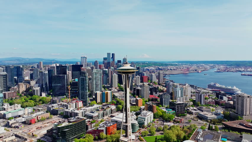 Aerial drone view over Seattle, Washington, USA, featuring the Space Needle and the surrounding downtown skyline. Ideal for travel, landmarks, and urban cityscape footage