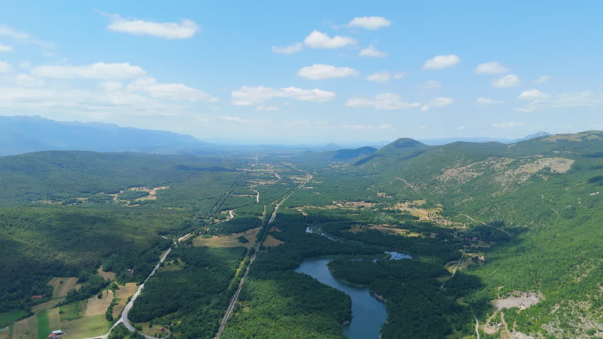 Views of green hills and lakes from above in a rural area