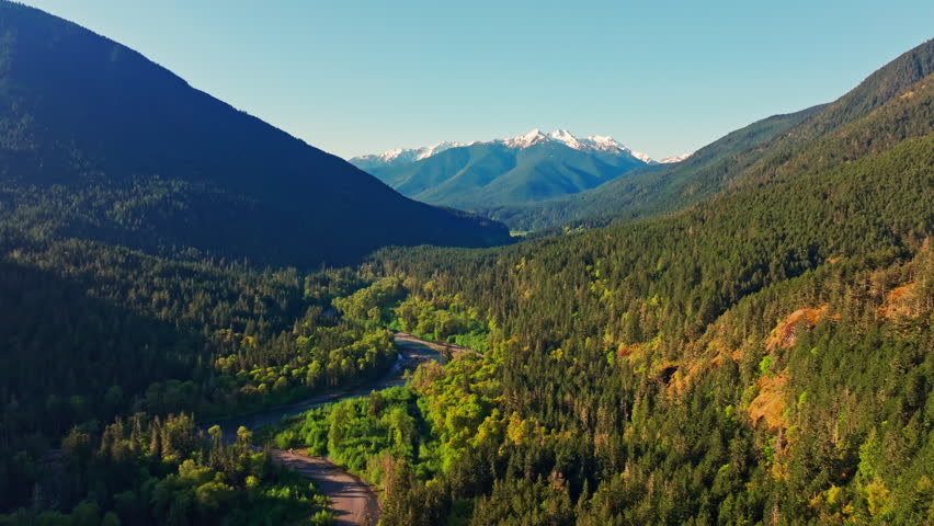 Aerial drone view of Olympic National Park in Washington, showcasing rugged mountain landscapes, forested slopes, and scenic alpine terrain. Ideal for nature and travel footage