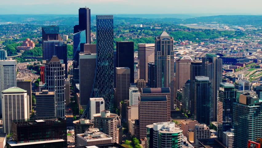 Aerial drone view of downtown Seattle, showcasing skyscrapers, urban streets, and the city skyline from above. Ideal for travel and urban cityscape footage
