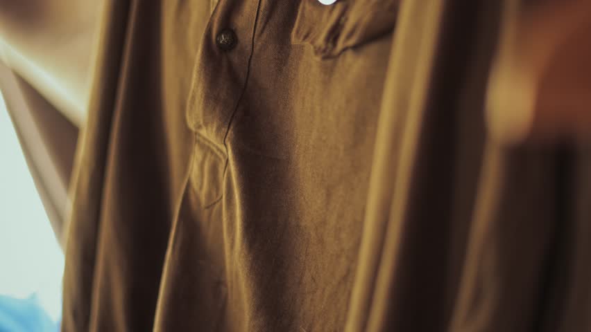 Close up detail view of Soviet military uniform, khaki fabric, shoulder straps of Red Army lieutenant, medals are on breast pocket, historical uniform from World War Two