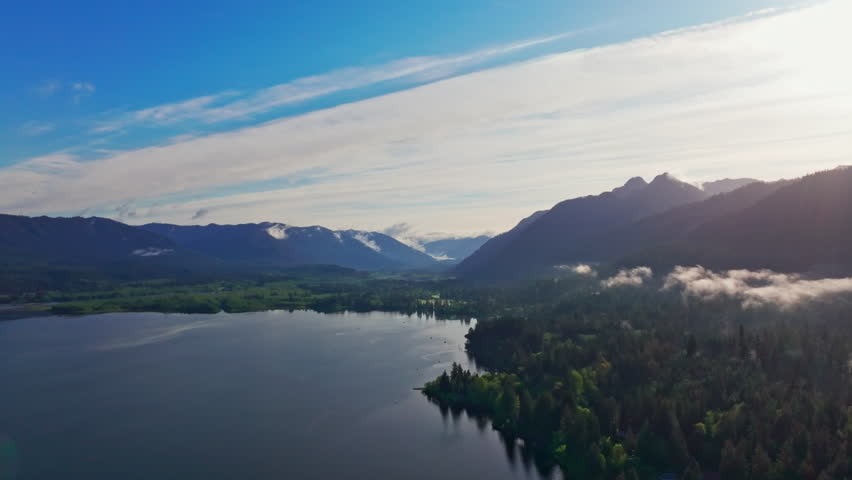 Aerial drone view of Lake Quinault in Olympic National Park, Washington, showing calm waters, dense rainforest, and mountain scenery. Ideal for nature, travel, and landscape footage