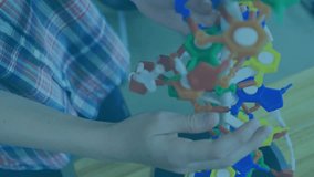 Animation of red shapes over caucasian schoolboy with model. school and education concept digitally generated video. - Powered by Shutterstock - Get 15% off with code: PIKWIZARD15