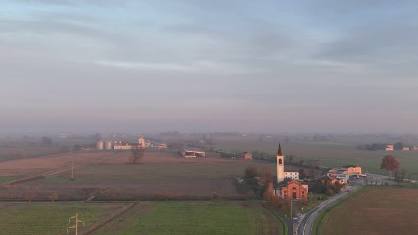 Aerial view of the San Bartolomeo Apostolo Church and the Trattoria La Resca area along the SS10 in Vescovato, Cremona.