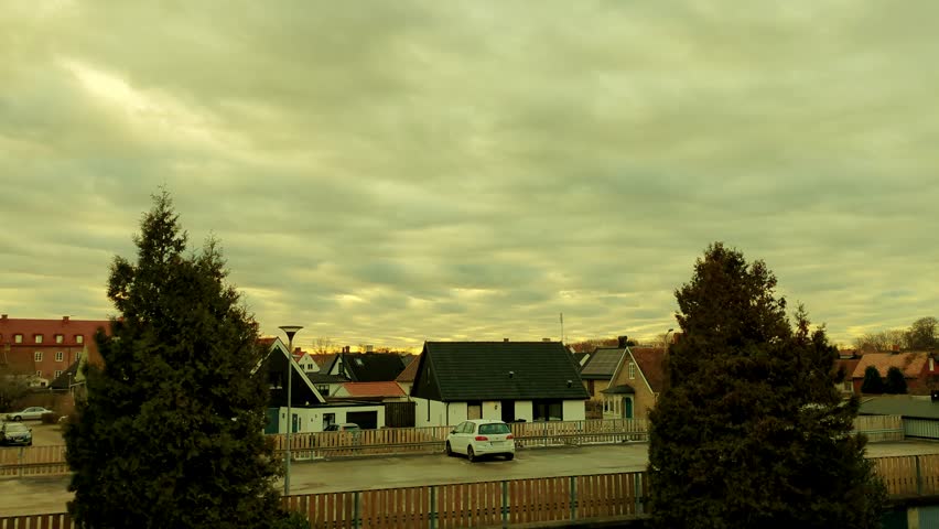 Time-lapse of Sunset over Houses in a Small Swedish Town.