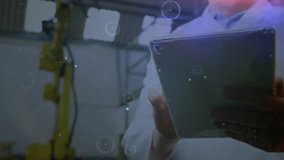 Engineer tapping and rotating tablet, activating AR data overlays for factory robotic diagnostics. Technology, innovation, user interface, industrial, futuristic, analysis, digital - Powered by Shutterstock - Get 15% off with code: PIKWIZARD15