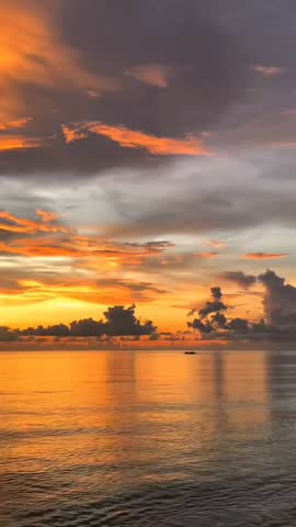 Breathtaking evening sky filled with vibrant orange and yellow clouds at dusk, creating a beautiful natural background.