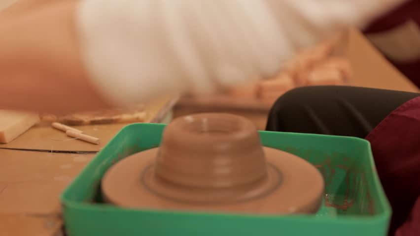 A potter makes a new clay vessel from clay. Pottery. The craft of throwing clay on a potter