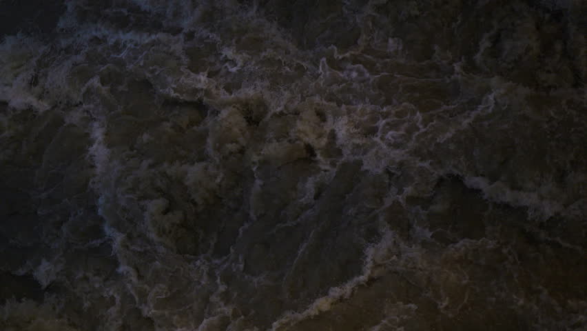 Turbulent Water Flow Beneath The Dam Gate, A powerful film clip of turbulent water flow, white foam churning violently, for hydropower force film or raw nature documentary.