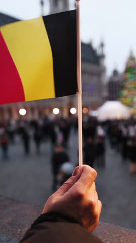 Young Woman With Belgian Flag In Grand Place Brussels With Tourists At New Year Holidays With Decorated Tree, Vertical Video