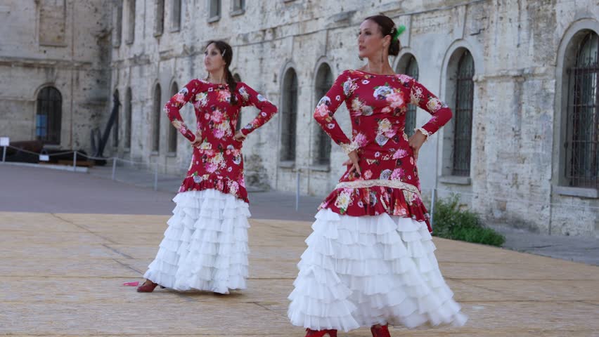 Flamenco Dancers in Red Dresses Performing on Spanish Old Town Square