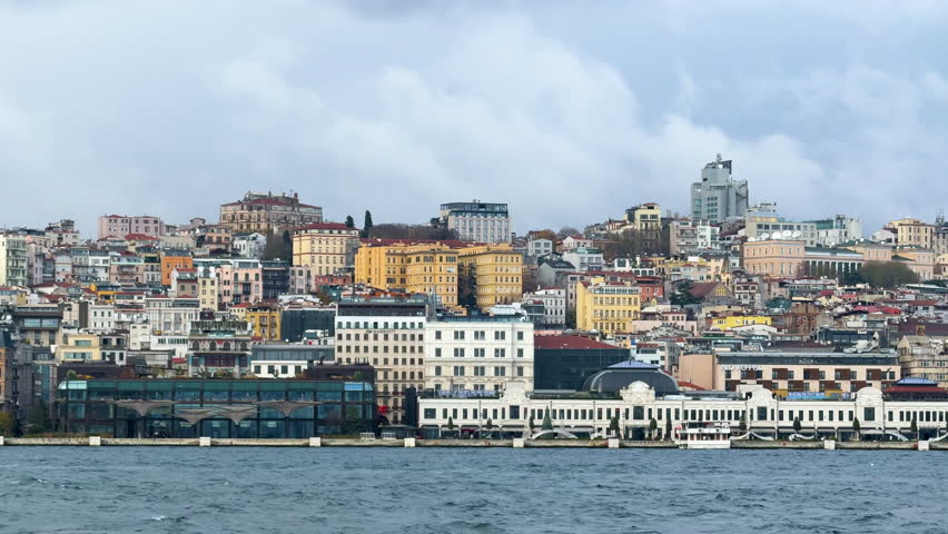Close up waterfront view of Istanbul skyline with city buildings and Bosphorus shoreline. Turkey.