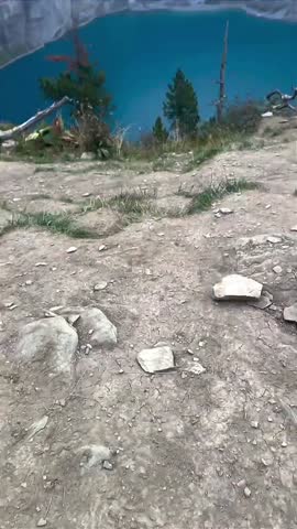 Foggy Mountain Lake with Turquoise Water and Cliffs