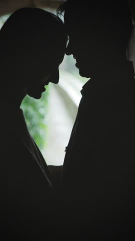 Romantic couple silhouette sharing intimate moments