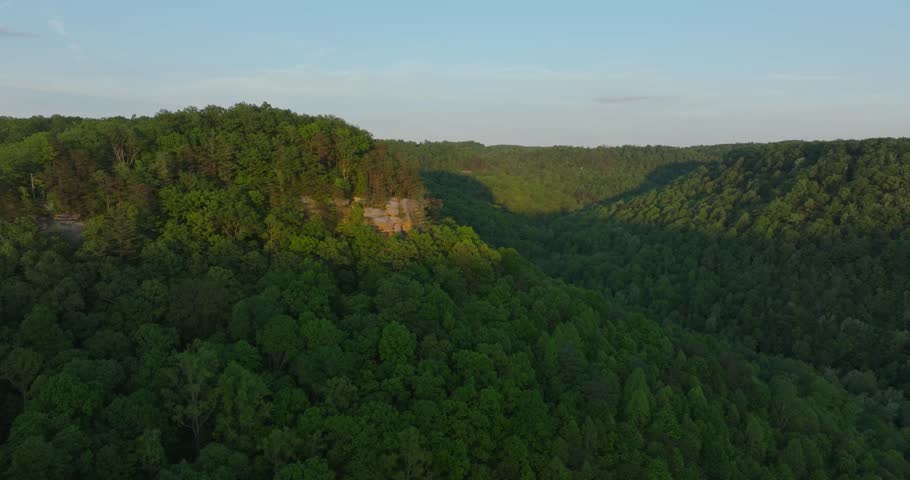 Lush forest hills and rocky overlook, Red River Gorge at sunset