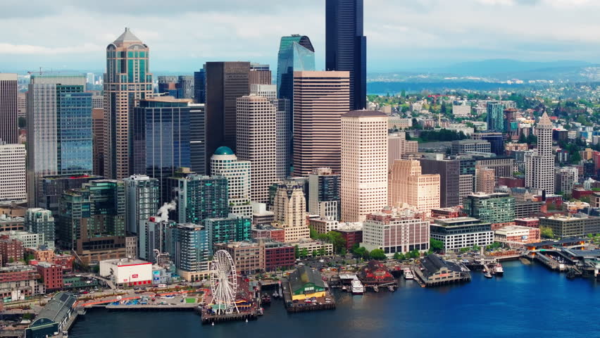 Aerial drone view of downtown Seattle, Washington, showcasing skyscrapers, modern architecture, and the dense urban skyline. Ideal for cityscape, travel, and commercial footage