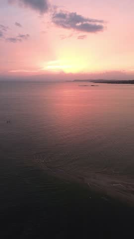 A beautiful sunset over the ocean with a boat in the water