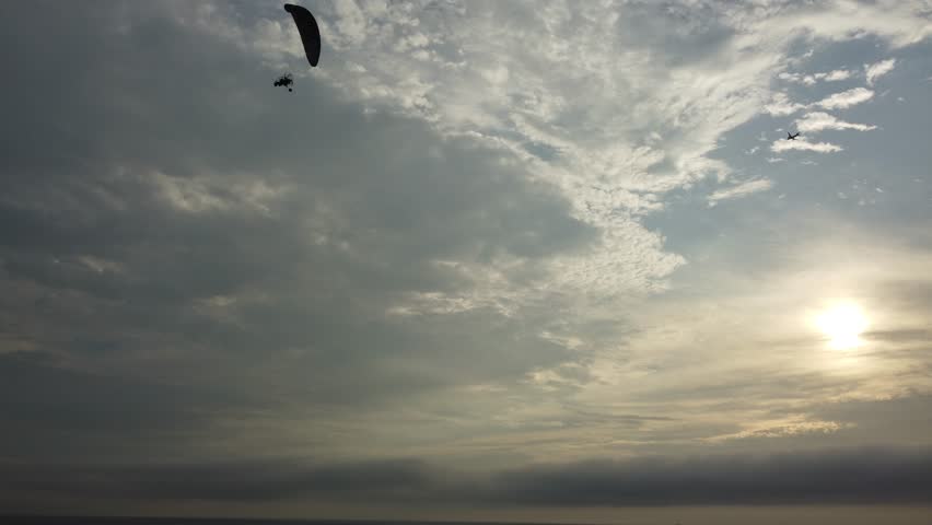 Peaceful twilight over ocean horizon, Calm dusk at shoreline featuring glowing sky and distant bird shadows