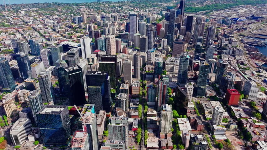 Aerial drone view of downtown Seattle, Washington, showcasing skyscrapers, urban streets, and the city’s modern skyline from above. Ideal for travel, cityscape, and urban environment footage