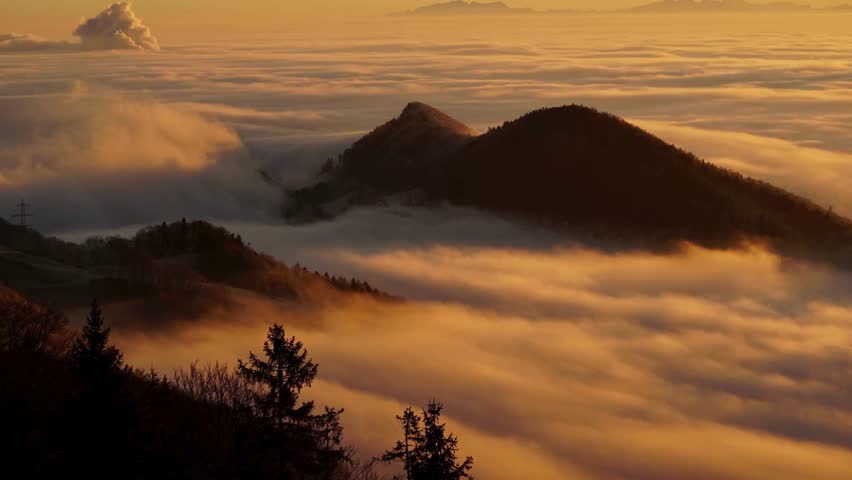 Scenic sunset sky with glowing clouds and warm natural colors as daylight fades. Atmospheric nature background with dramatic cloud formations and peaceful evening mood.