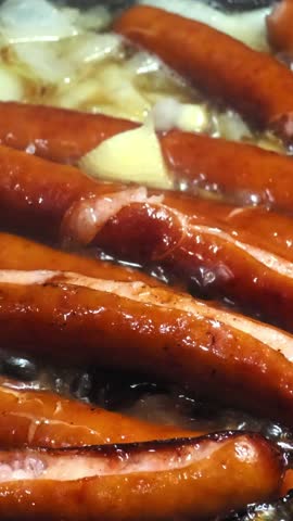 Juicy roasted sausages close up representing comfort food and indulgence, vertical video