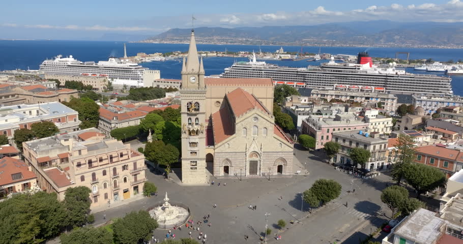 Aerial view of the Cathedral Basilica of Santa Maria Assunta, located in the center of Messina, Sicily, Italy. In the background is the Strait of Messina and across the sea, the Calabrian coast. 