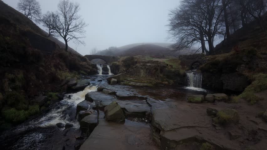 A cold winter misty morning in a remote valley with waterfalls and ponds. 3 Shires heads. UK