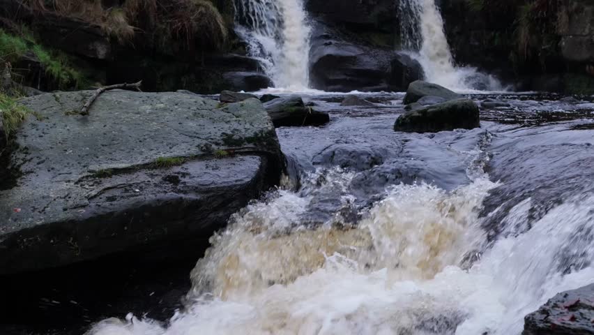 A cold winter misty morning in a remote valley with waterfalls and ponds. 3 Shires heads. UK