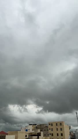 Dark Grey Storm Clouds Rolling Over City Rooftops Before Rain



A dramatic shot of heavy, dark grey storm clouds filling the sky over a residential city area. The atmosphere is ominous and moody, signaling an approaching thunderstorm or monsoon. Below the turbulent sky, beige concrete buildings and rooftops are visible, creating a contrast between the urban environment and the power of nature. This footage is excellent for weather updates, dramatic storytelling, climate change concepts, and disaster-themed content.