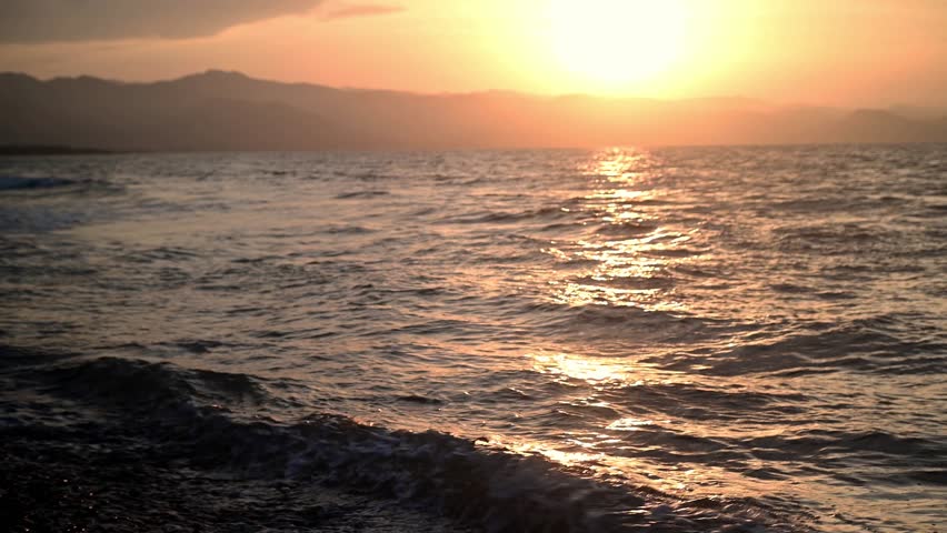 A pure, uncluttered shot of a Cyprus coastline at sunset. The calm Mediterranean Sea meets the shore under a gradient sky. Ultimate serenity and escape.