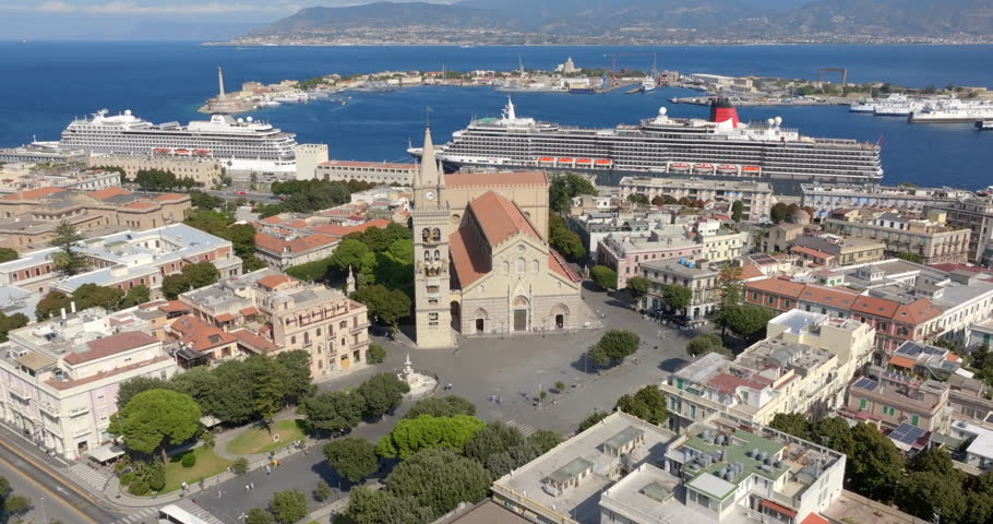 Aerial view of the Cathedral Basilica of Santa Maria Assunta, located in the center of Messina, Sicily, Italy. In the background is the Strait of Messina and across the sea, the Calabrian coast. 
