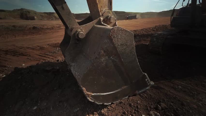 Yellow Bulldozer on Dark Soil Hill.