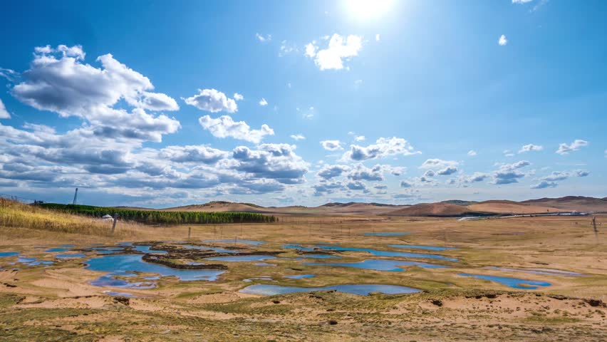 This 4K aerial time-lapse video unfolds the breathtaking natural scenery of the Qinghai-Tibet Plateau in Qinghai, featuring snow-capped peaks piercing the blue sky, endless alpine grasslands stretching far and wide, crystal-clear plateau lakes with perfect sky reflections, and dynamic cloud movements over the high-altitude land. Capturing the dramatic light changes from sunrise to sunset and misty morning vistas, it vividly presents the grand, primitive wild beauty and unique plateau ecology of this iconic tourist spot, ideal for tourism promotions, nature documentaries and outdoor travel content creation.